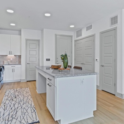 a kitchen with white cabinets and a kitchen island