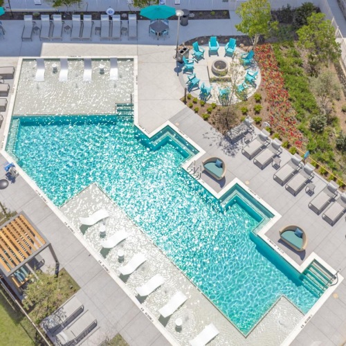 a large swimming pool next to a building